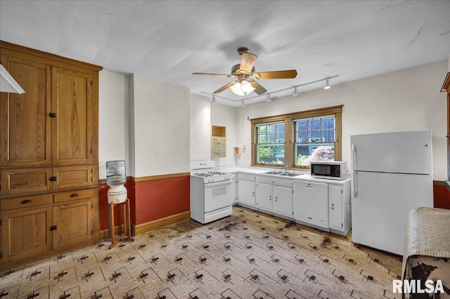 1027 N Maplewood Ave, Peoria, IL 61606 - kitchen with white appliances, ceiling fan, light countertops, rail lighting, and brown cabinets