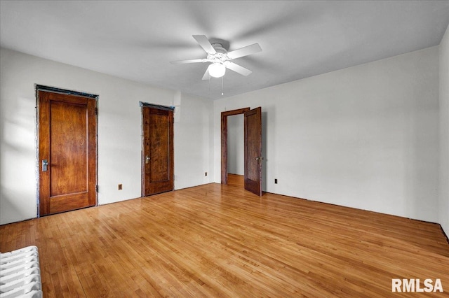1027 N Maplewood Ave, Peoria, IL 61606 - unfurnished bedroom with light wood-style flooring and a ceiling fan