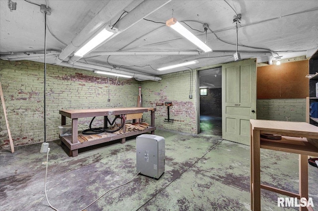 1027 N Maplewood Ave, Peoria, IL 61606 - unfinished basement with a workshop area and brick wall
