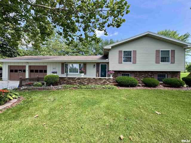 2001 W Jackson St Unit C, Macomb, IL 61455 - split level home with board and batten siding, a garage, a front yard, and concrete driveway