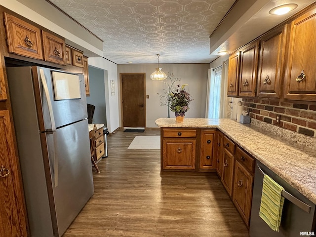 2001 W Jackson St Unit C, Macomb, IL 61455 - kitchen with freestanding refrigerator, an ornate ceiling, stainless steel dishwasher, a peninsula, and light countertops