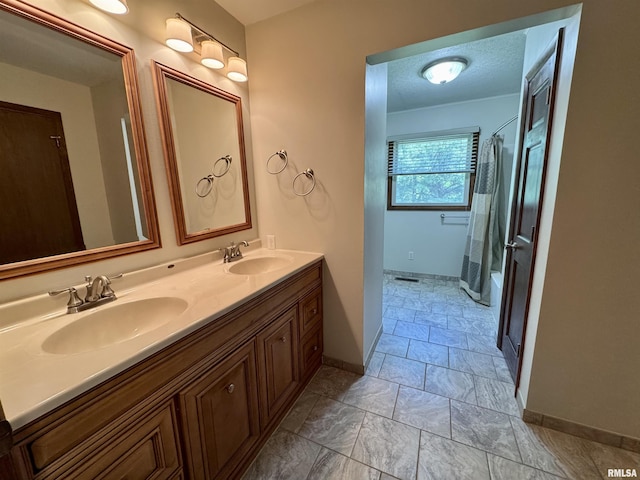 2001 W Jackson St Unit C, Macomb, IL 61455 - bathroom featuring double vanity and marble look tiles