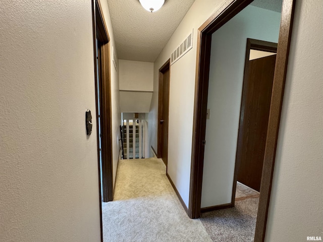 2001 W Jackson St Unit C, Macomb, IL 61455 - hallway with an upstairs landing, carpet floors, a textured ceiling, and a textured wall