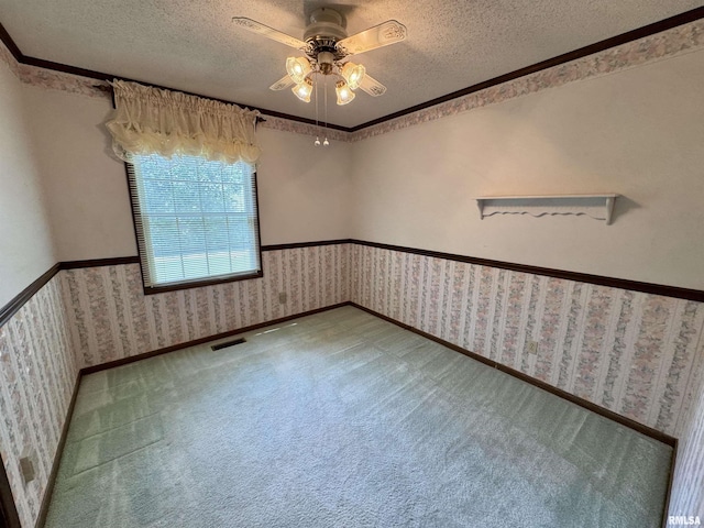 2001 W Jackson St Unit C, Macomb, IL 61455 - carpeted spare room featuring a textured ceiling, wallpapered walls, a ceiling fan, and crown molding