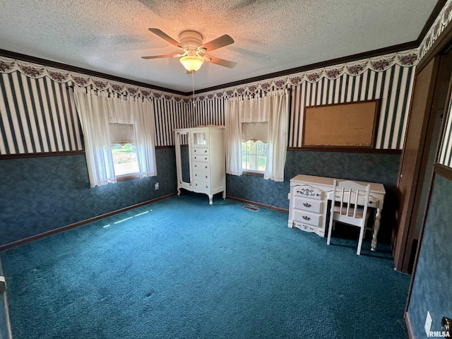 2001 W Jackson St Unit C, Macomb, IL 61455 - unfurnished bedroom with wallpapered walls, a textured ceiling, carpet flooring, and a ceiling fan