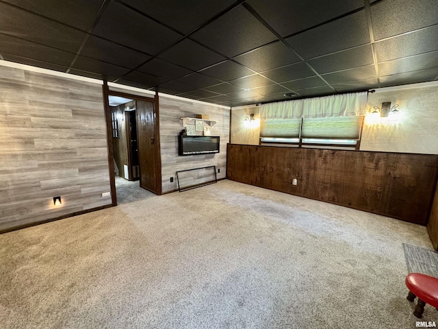 2001 W Jackson St Unit C, Macomb, IL 61455 - unfurnished living room featuring wood walls, carpet, and a drop ceiling