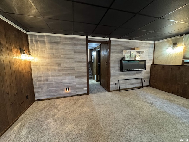 2001 W Jackson St Unit C, Macomb, IL 61455 - unfurnished living room featuring carpet flooring, wood walls, a drop ceiling, and a fireplace