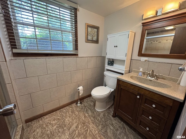 2001 W Jackson St Unit C, Macomb, IL 61455 - bathroom featuring tile walls, vanity, a shower, and a wainscoted wall