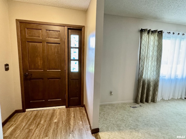 2001 W Jackson St Unit C, Macomb, IL 61455 - foyer entrance with a textured ceiling and baseboards