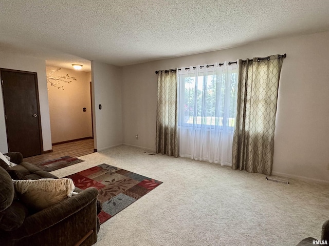 2001 W Jackson St Unit C, Macomb, IL 61455 - living area featuring a textured ceiling and carpet