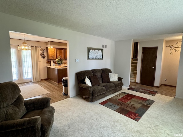 2001 W Jackson St Unit C, Macomb, IL 61455 - living area with a textured ceiling, light colored carpet, and a chandelier