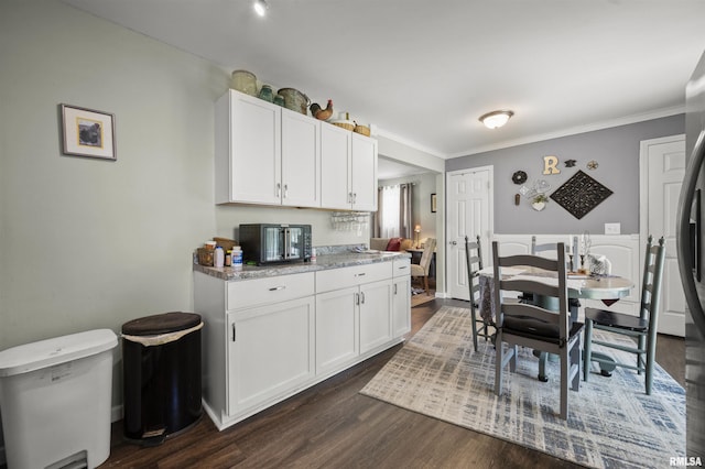 2227 W Westport Rd, Peoria, IL 61615 - kitchen featuring dark wood-style flooring, white cabinetry, crown molding, and light stone countertops