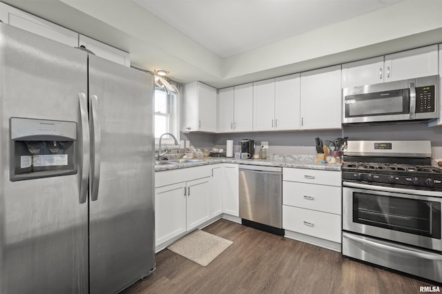 2227 W Westport Rd, Peoria, IL 61615 - kitchen featuring stainless steel appliances, white cabinetry, dark wood-type flooring, and light stone countertops
