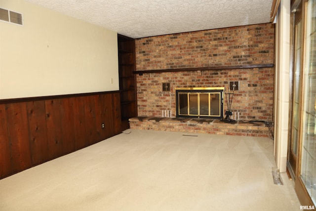 307 N Toepfer St, Tremont, IL 61568 - unfurnished living room with carpet, a textured ceiling, a wainscoted wall, wooden walls, and a brick fireplace