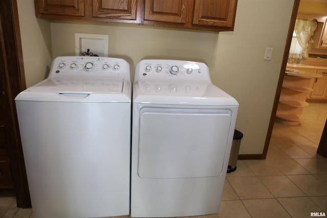 307 N Toepfer St, Tremont, IL 61568 - washroom with washing machine and dryer, cabinet space, and light tile patterned floors