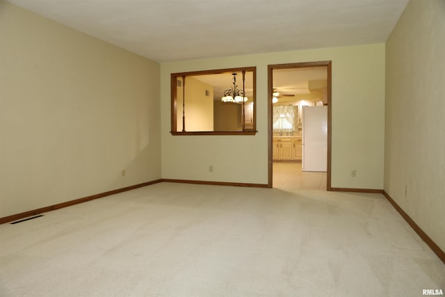 307 N Toepfer St, Tremont, IL 61568 - unfurnished room with light carpet and a chandelier