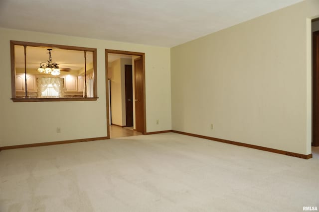 307 N Toepfer St, Tremont, IL 61568 - spare room with light colored carpet and a chandelier