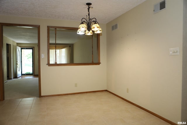 307 N Toepfer St, Tremont, IL 61568 - spare room featuring a chandelier, a textured ceiling, and light tile patterned flooring