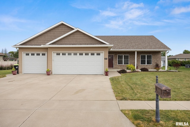 109 E Lee St, Tremont, IL 61568 - view of front of house with driveway, a front lawn, an attached garage, and brick siding