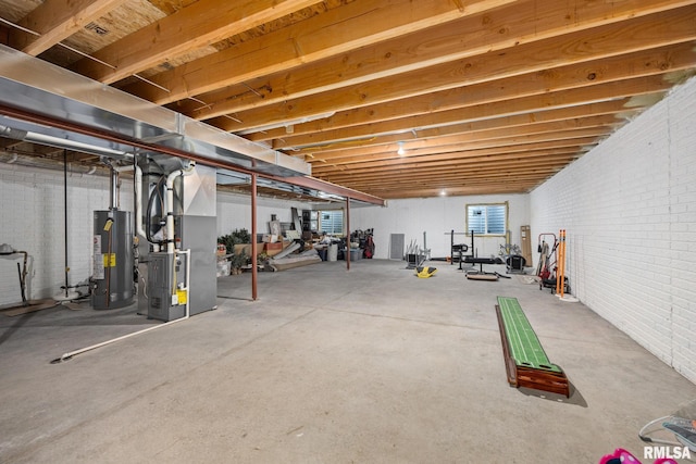 109 E Lee St, Tremont, IL 61568 - unfinished below grade area with gas water heater, brick wall, and heating unit