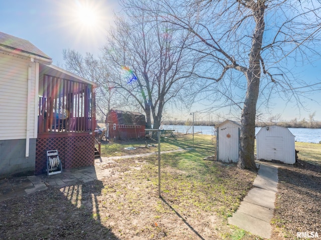 6334 Macs Rd, Manito, IL 61546 - view of grassy yard with a storage unit, a water view, and a sunroom