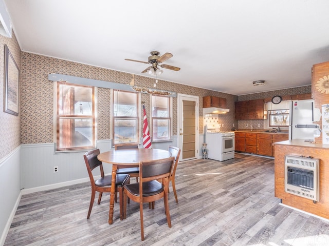 6334 Macs Rd, Manito, IL 61546 - dining space featuring heating unit, light wood-style flooring, a ceiling fan, wallpapered walls, and wainscoting