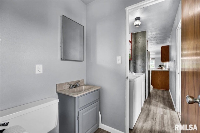 14100 Glasford-Canton Rd, Glasford, IL 61533 - bathroom featuring washer and dryer, vanity, and wood finished floors