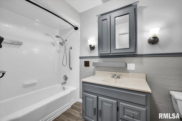 14100 Glasford-Canton Rd, Glasford, IL 61533 - bathroom featuring vanity,  shower combination, wood finished floors, and wainscoting