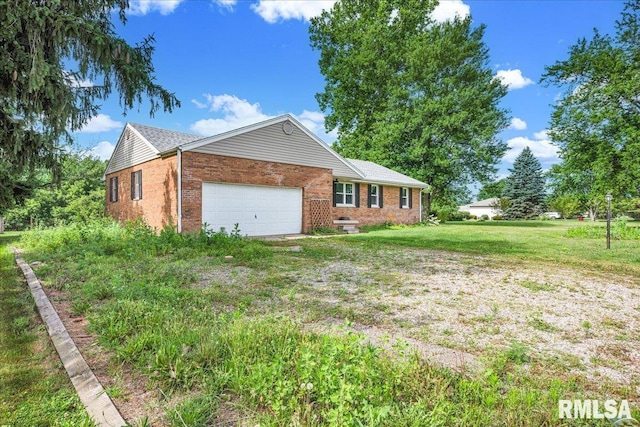 14100 Glasford-Canton Rd, Glasford, IL 61533 - view of front of house featuring brick siding, an attached garage, and a front yard