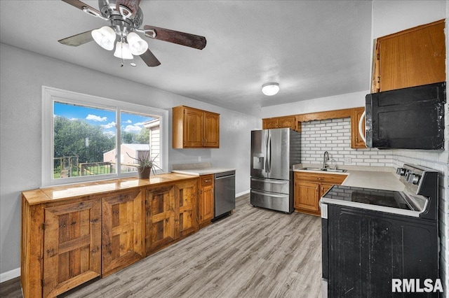 14100 Glasford-Canton Rd, Glasford, IL 61533 - kitchen featuring black appliances, brown cabinets, light countertops, a ceiling fan, and light wood-style floors