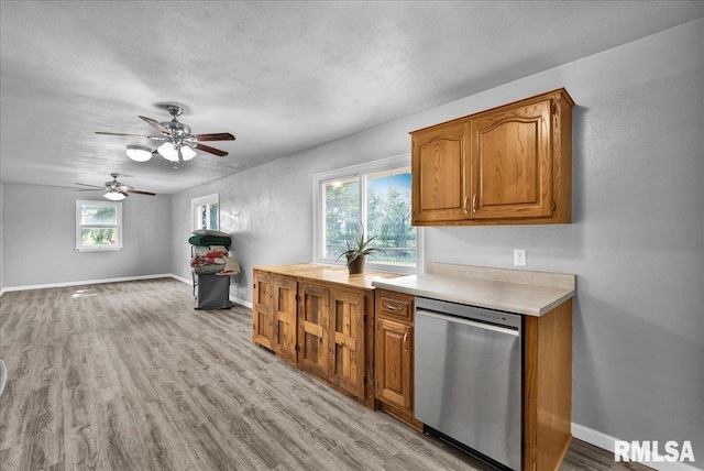 14100 Glasford-Canton Rd, Glasford, IL 61533 - kitchen featuring dishwasher, brown cabinets, light wood-style floors, light countertops, and ceiling fan