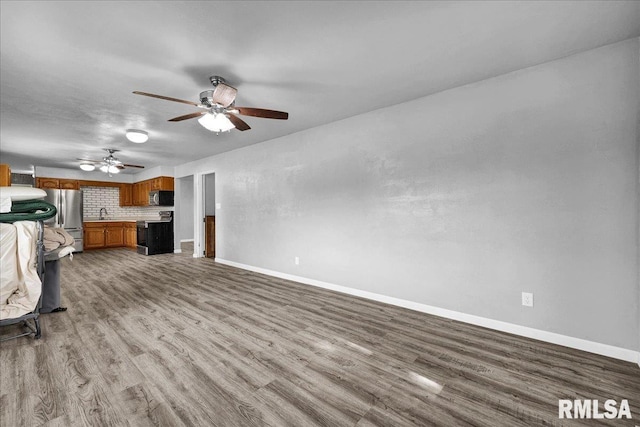 14100 Glasford-Canton Rd, Glasford, IL 61533 - unfurnished living room featuring wood finished floors and a ceiling fan