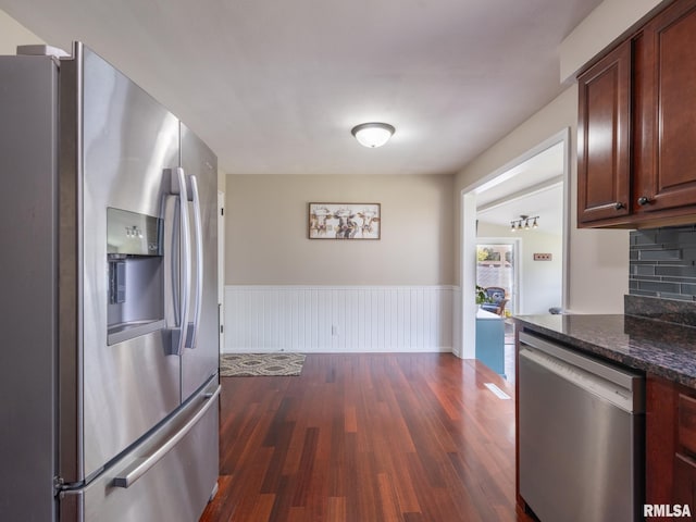 1100 Hampton Rd, Washington, IL 61571 - kitchen with appliances with stainless steel finishes, dark wood-type flooring, wainscoting, and dark stone counters