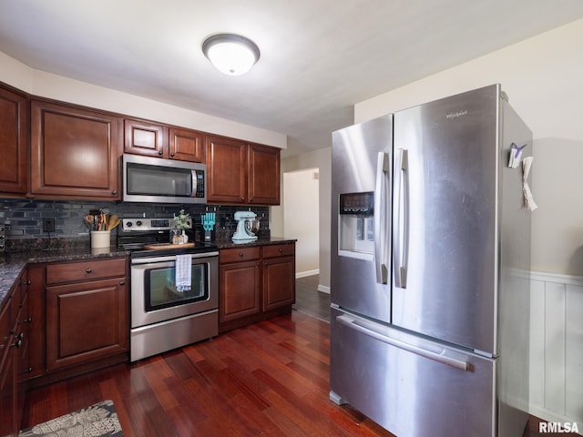 1100 Hampton Rd, Washington, IL 61571 - kitchen featuring appliances with stainless steel finishes, tasteful backsplash, dark wood-style floors, and dark stone counters