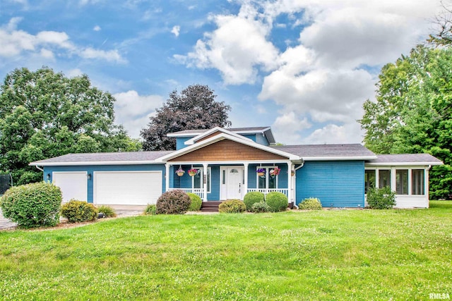 499 Goodsill Dr, East Galesburg, IL 61430 - view of front of property with a garage, covered porch, a front yard, and roof with shingles