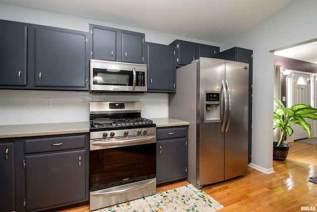 499 Goodsill Dr, East Galesburg, IL 61430 - kitchen featuring appliances with stainless steel finishes, light wood finished floors, light countertops, and backsplash