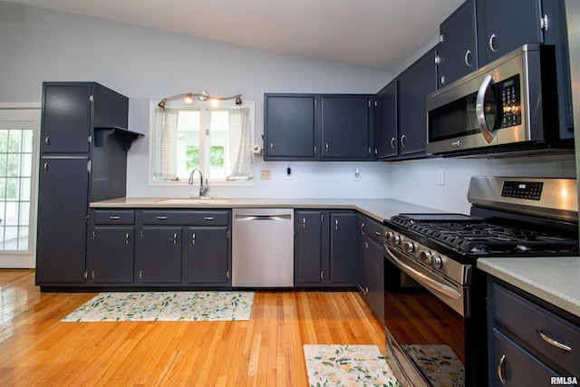499 Goodsill Dr, East Galesburg, IL 61430 - kitchen with stainless steel appliances, vaulted ceiling, light wood-style floors, healthy amount of natural light, and light countertops