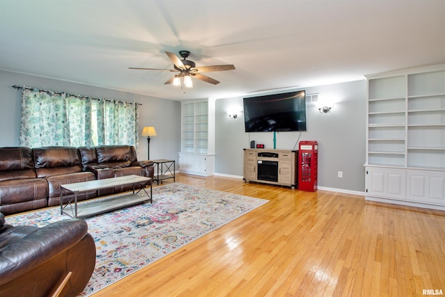 499 Goodsill Dr, East Galesburg, IL 61430 - living area featuring a ceiling fan, light wood finished floors, and built in features