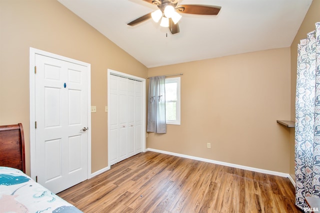 499 Goodsill Dr, East Galesburg, IL 61430 - unfurnished bedroom with vaulted ceiling, light wood-style flooring, a closet, and ceiling fan
