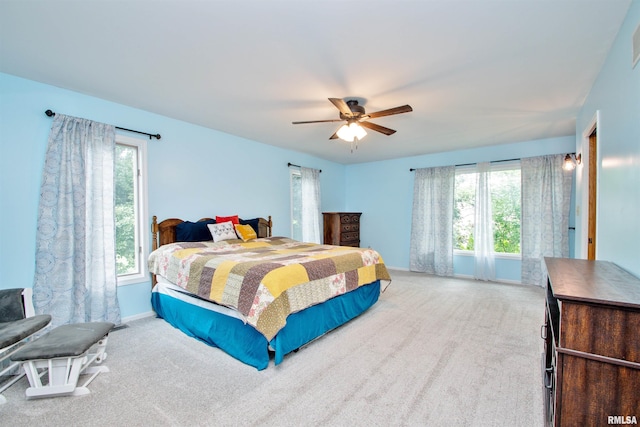 499 Goodsill Dr, East Galesburg, IL 61430 - carpeted bedroom featuring multiple windows and ceiling fan