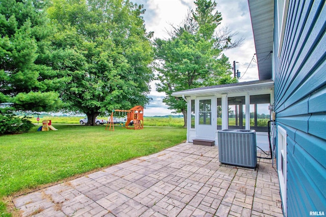 499 Goodsill Dr, East Galesburg, IL 61430 - view of patio featuring a playground and a sunroom