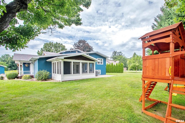 499 Goodsill Dr, East Galesburg, IL 61430 - back of house with a yard and a sunroom