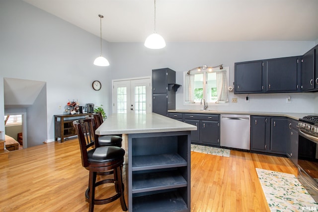 499 Goodsill Dr, East Galesburg, IL 61430 - kitchen with stainless steel appliances, open shelves, high vaulted ceiling, light wood-style floors, and light countertops