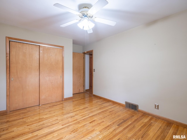 204 Ivanhoe Way, Bloomington, IL 61701 - unfurnished bedroom with a closet, light wood-type flooring, and a ceiling fan