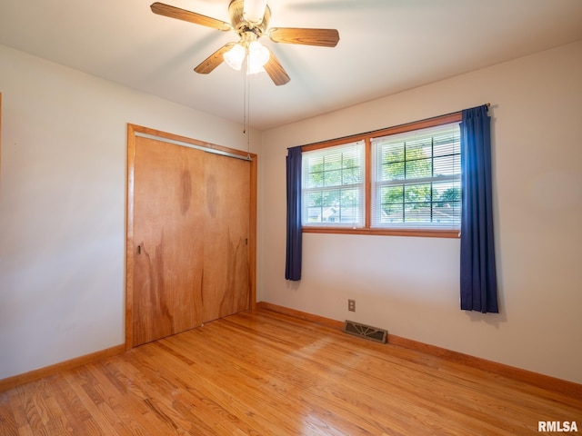 204 Ivanhoe Way, Bloomington, IL 61701 - unfurnished bedroom with light wood finished floors, a closet, and ceiling fan