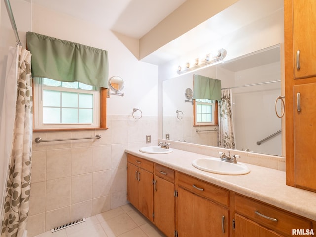 204 Ivanhoe Way, Bloomington, IL 61701 - full bath featuring double vanity, tile patterned flooring, tile walls, a wainscoted wall, and curtained shower
