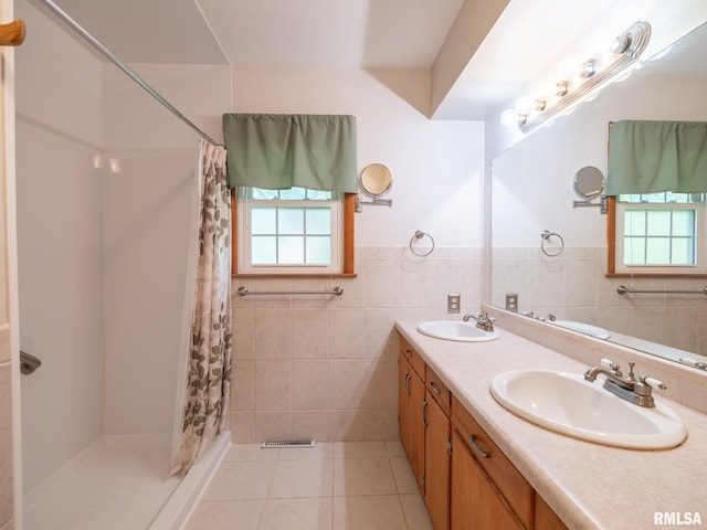 204 Ivanhoe Way, Bloomington, IL 61701 - full bath featuring plenty of natural light, double vanity, a shower with curtain, tile patterned flooring, and a wainscoted wall