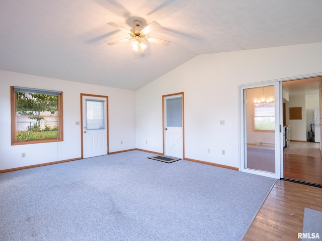 204 Ivanhoe Way, Bloomington, IL 61701 - unfurnished living room featuring lofted ceiling, a ceiling fan, healthy amount of natural light, carpet flooring, and wood finished floors