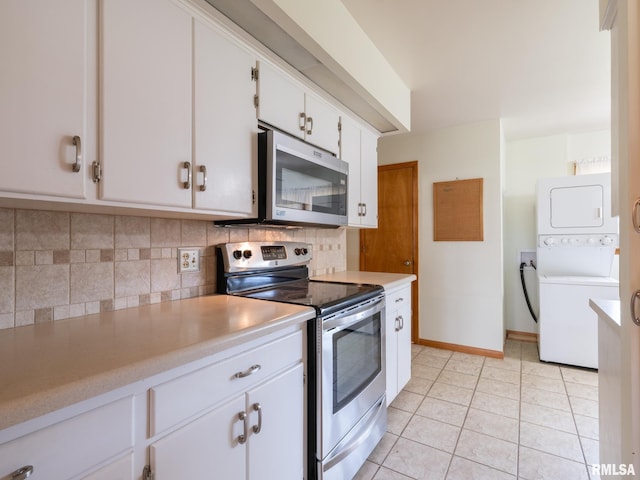 204 Ivanhoe Way, Bloomington, IL 61701 - kitchen featuring stainless steel appliances, stacked washing machine and dryer, backsplash, light countertops, and white cabinetry