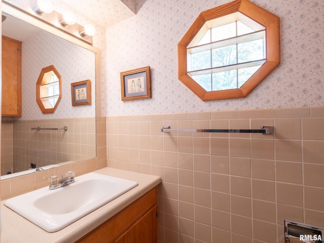 204 Ivanhoe Way, Bloomington, IL 61701 - bathroom with vanity, wallpapered walls, a wainscoted wall, and tile walls